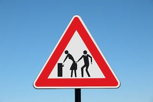 triangle warning sign with a stick woman bending over to put something in a bin and a stick man behind her touching her behind