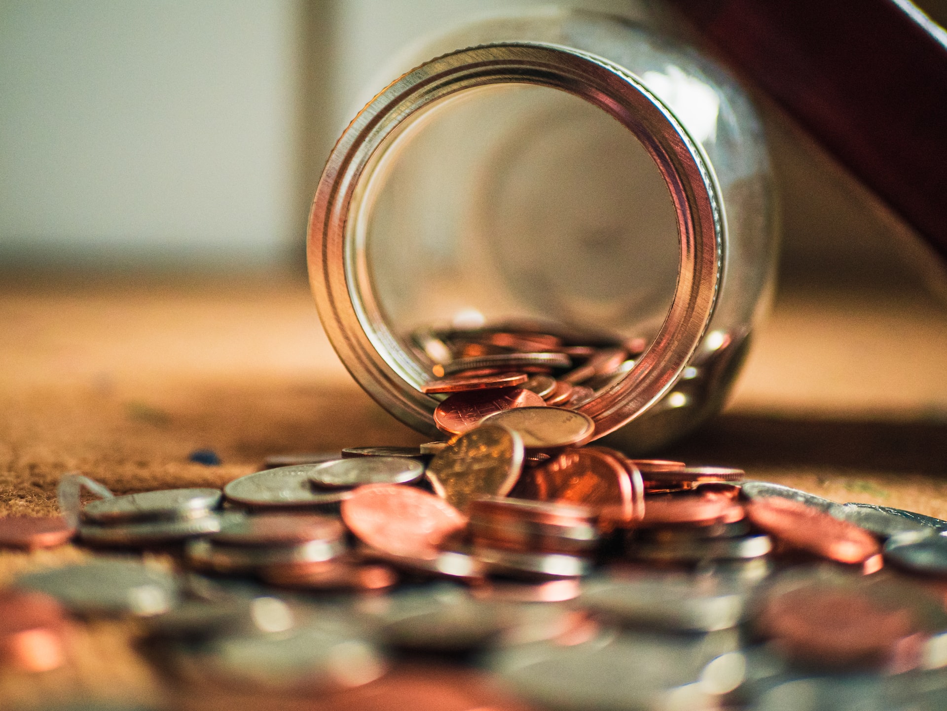 tipped over mason jar with coins in it