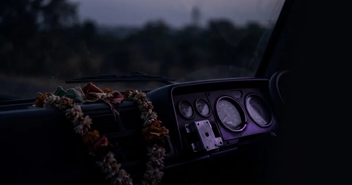 A truck on an Indian highway with a graphic overlay showing a GPS signal, representing the AIS-140 mandate for commercial vehicles.