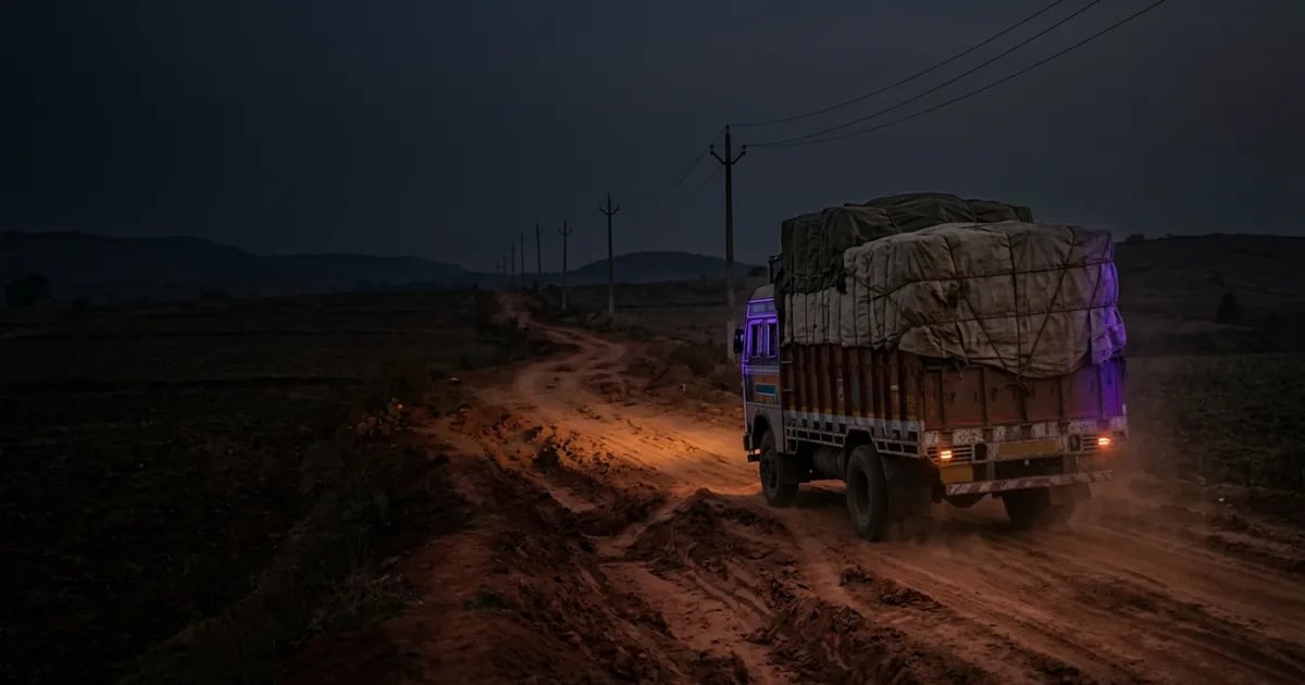 A truck driver using a mobile phone with an offline proof of delivery app in a remote industrial area with poor network signal
