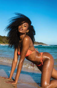 Shoreline Siren: Voluminous Curls and Peach Bikini Vibe
