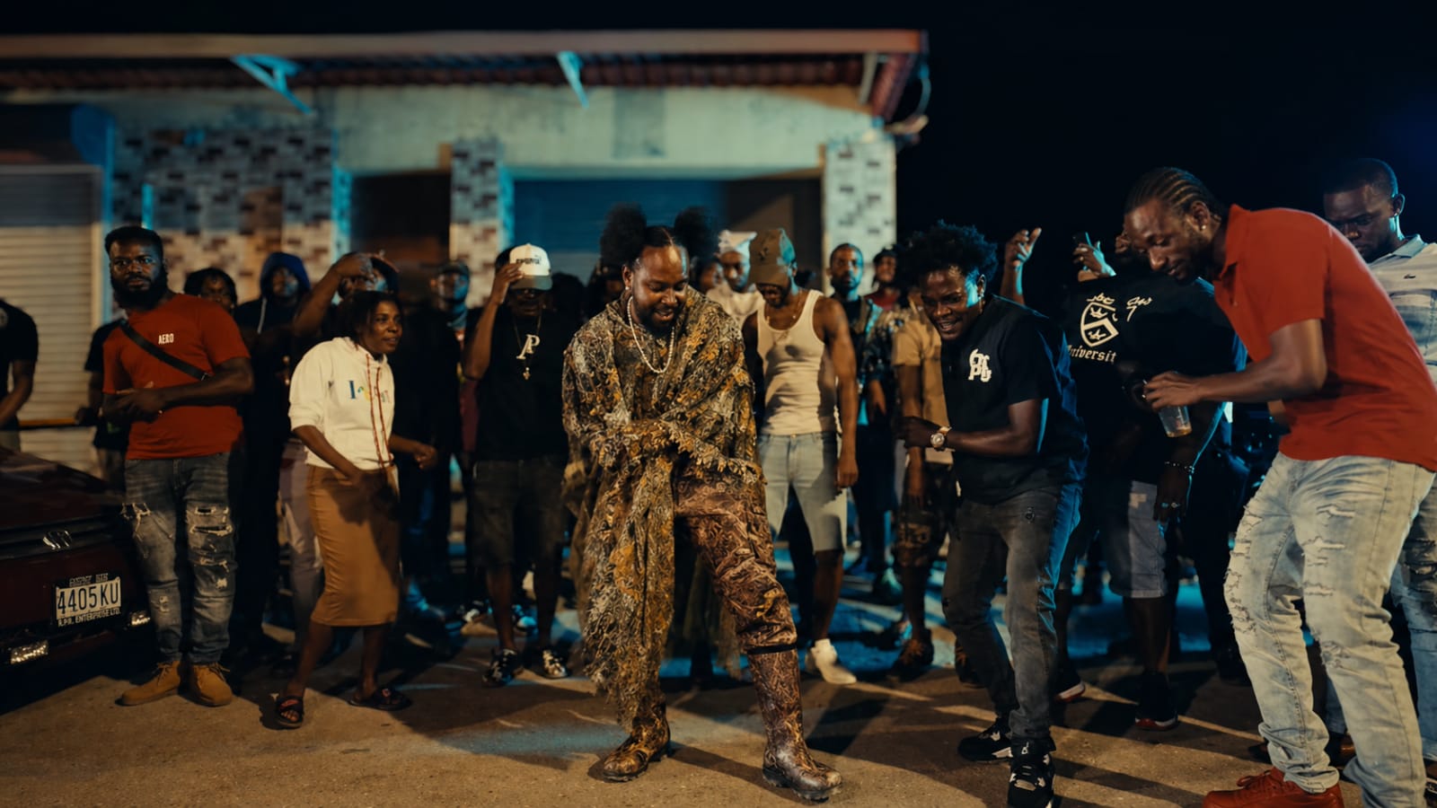Popcaan surrounded by his people in an Unruly street video frame