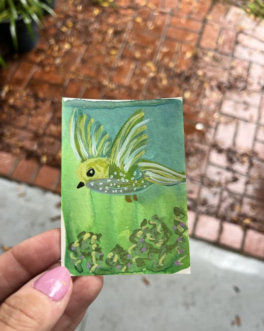 Green bird in flight