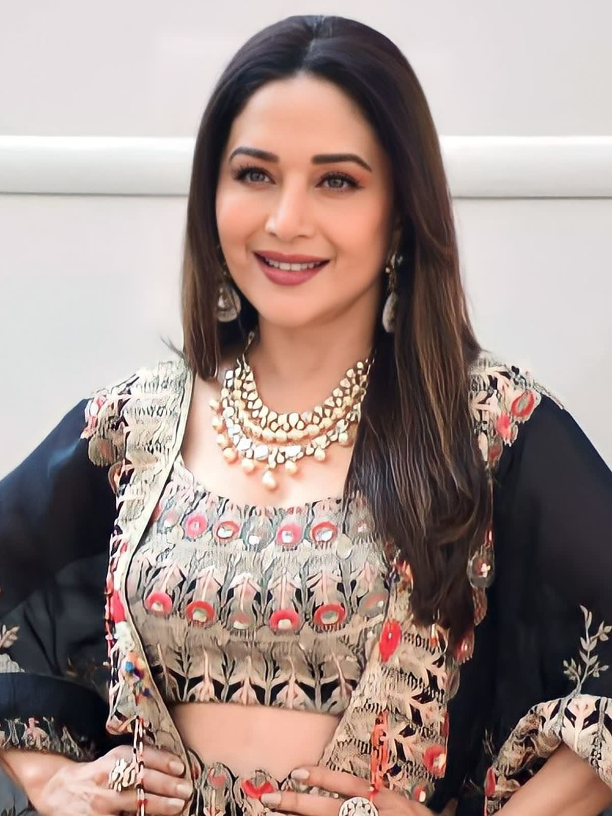 Madhuri Dixit smiling in an embroidered outfit on the sets of Jhalak Dikhhla Jaa in November 2022