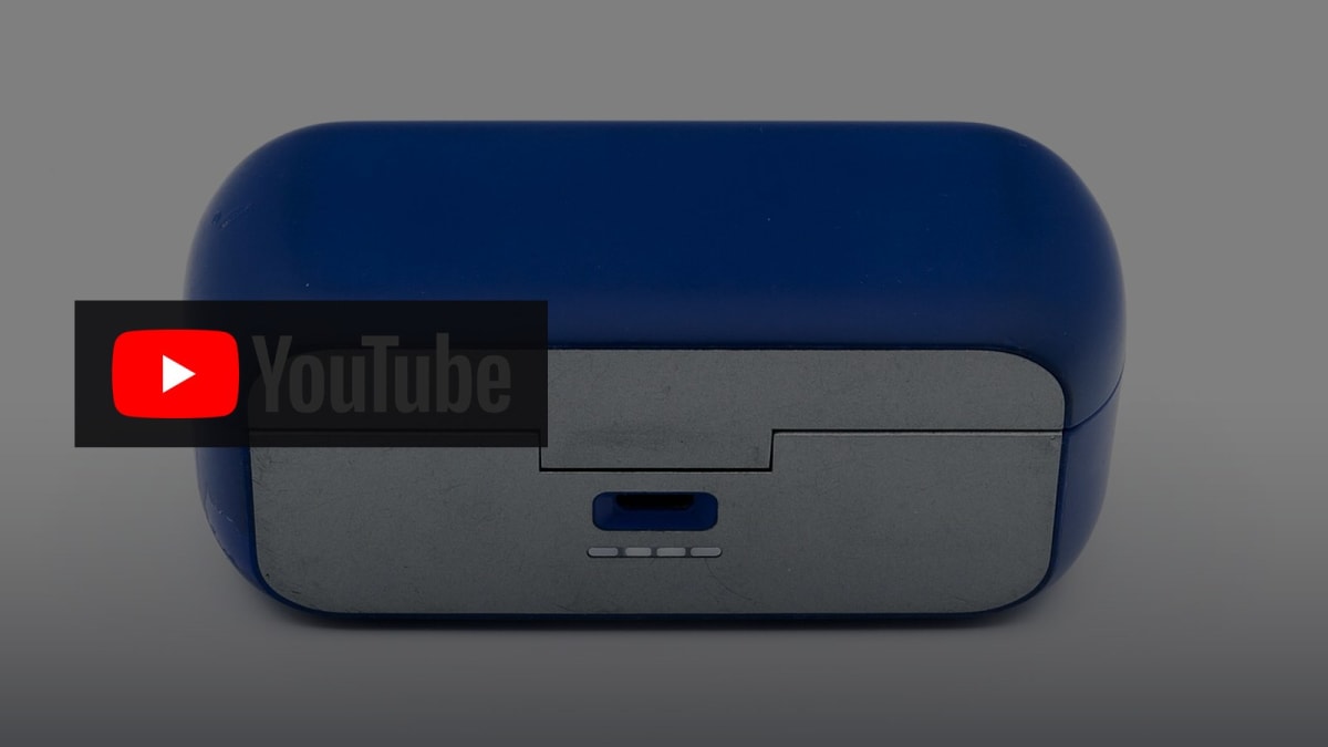 Official YouTube wordmark on photoreal dark studio/headphones editorial for YouTube AI music labels 2026. Photoreal brand cover.
