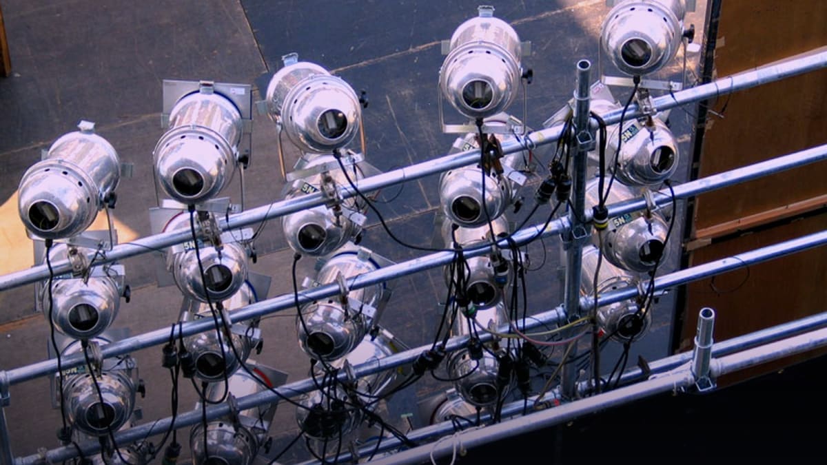 Photoreal concert stage lights still for ILLIT BREAK EVEN ADVANCE Oct 26 2026; no member faces available on Wikimedia.
