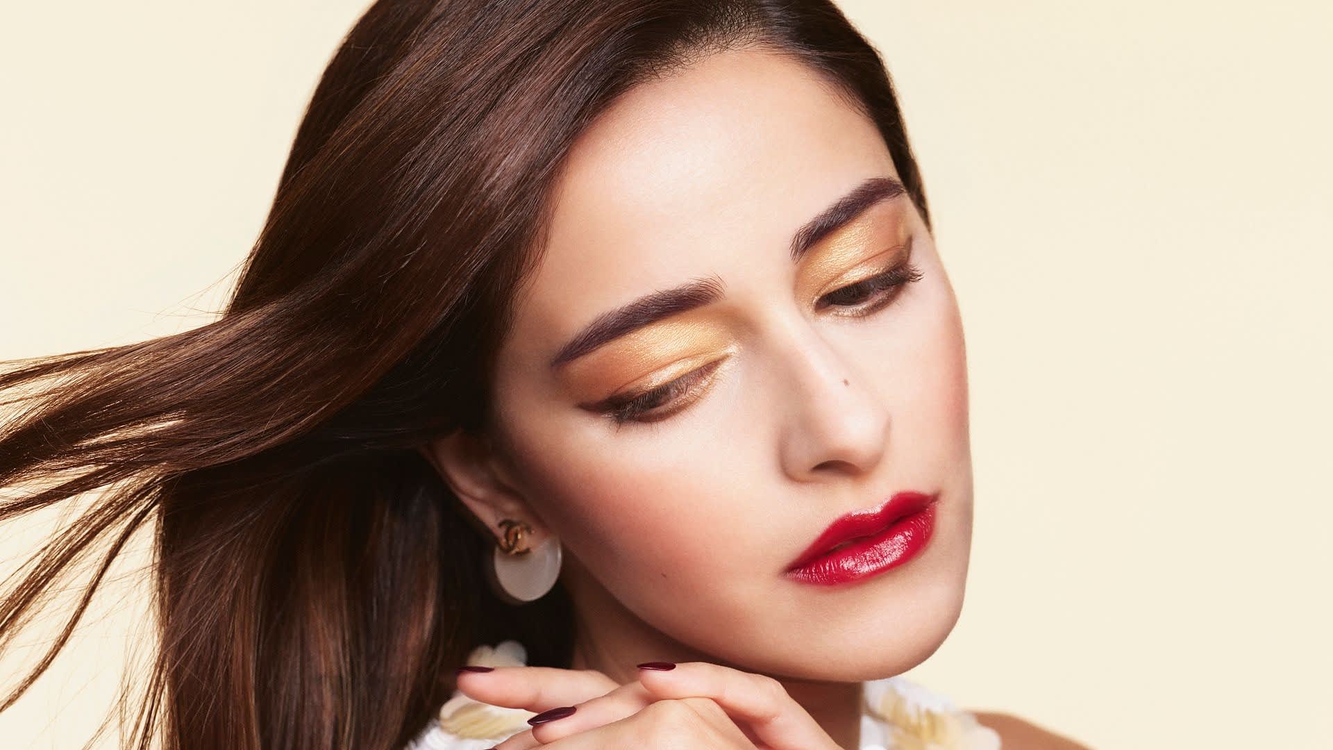 Ananya Panday in Chanel's Diwali 2026 beauty campaign wearing shimmering gold metallic eyeshadow and a bold red lip