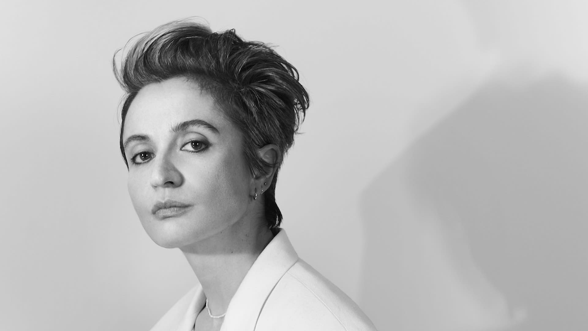 Black-and-white portrait of designer Veronica Leoni in a white blazer, the Calvin Klein Collection creative director who is leaving the brand