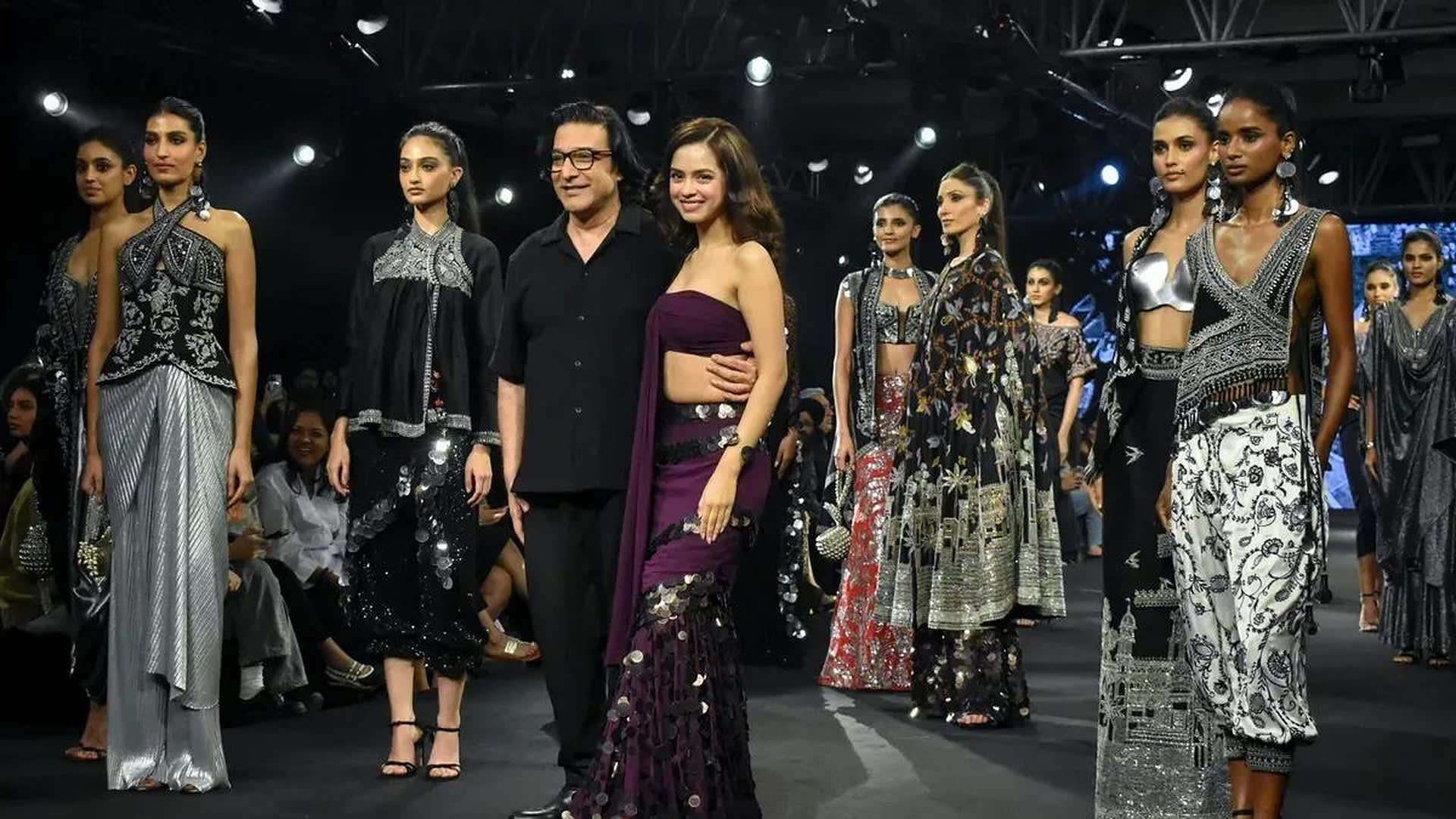 Designer Suneet Varma with showstopper Nitanshi Goel in a wine fishtail lehenga and models in Kashi looks at the finale, Lakmé Fashion Week x FDCI 2026, New Delhi