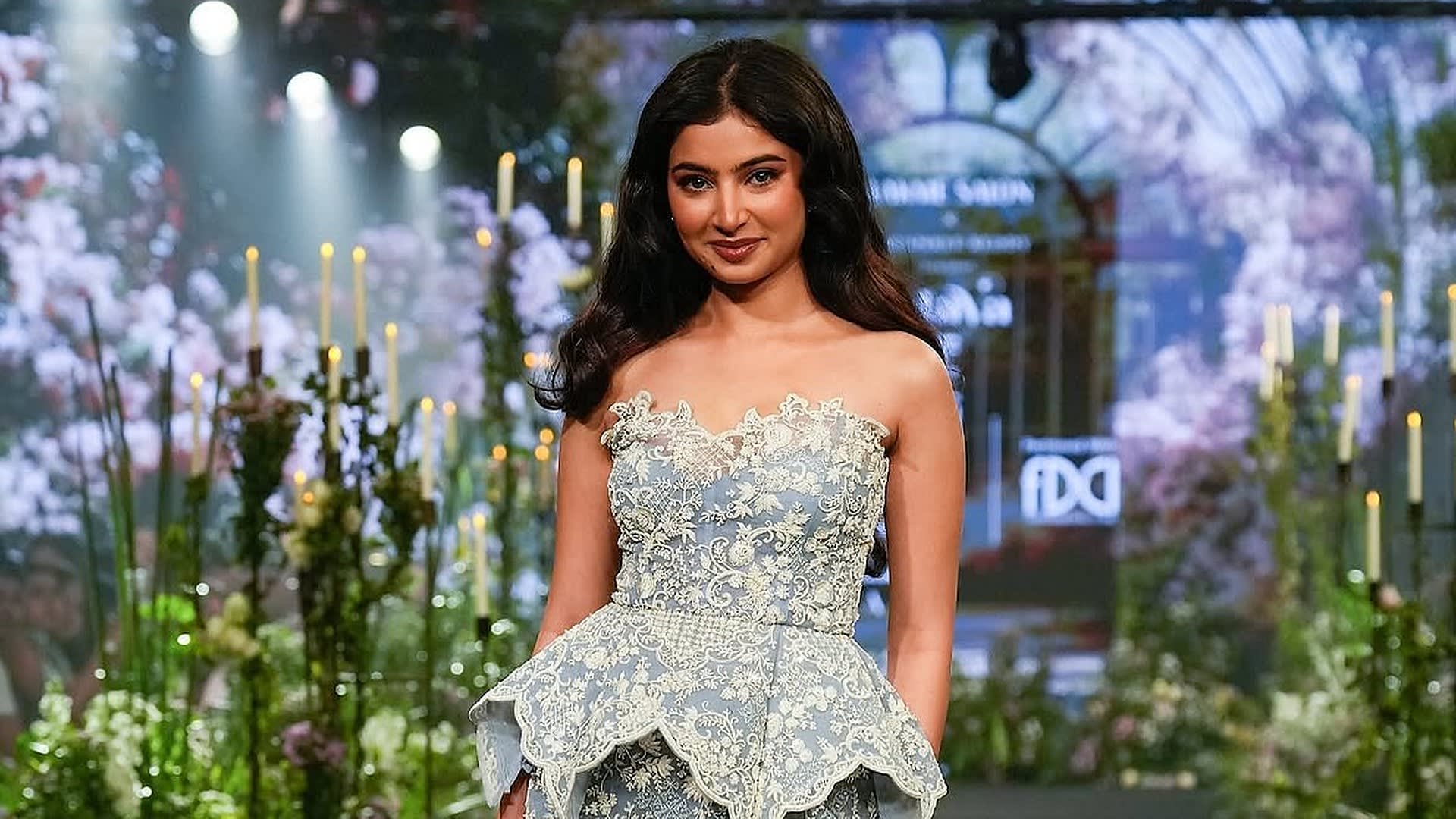 Sara Arjun walks the runway as showstopper for Anushree Reddy's MAYA collection in a strapless powder-blue embroidered peplum gown at Lakmé Fashion Week x FDCI, New Delhi, 16 October 2026