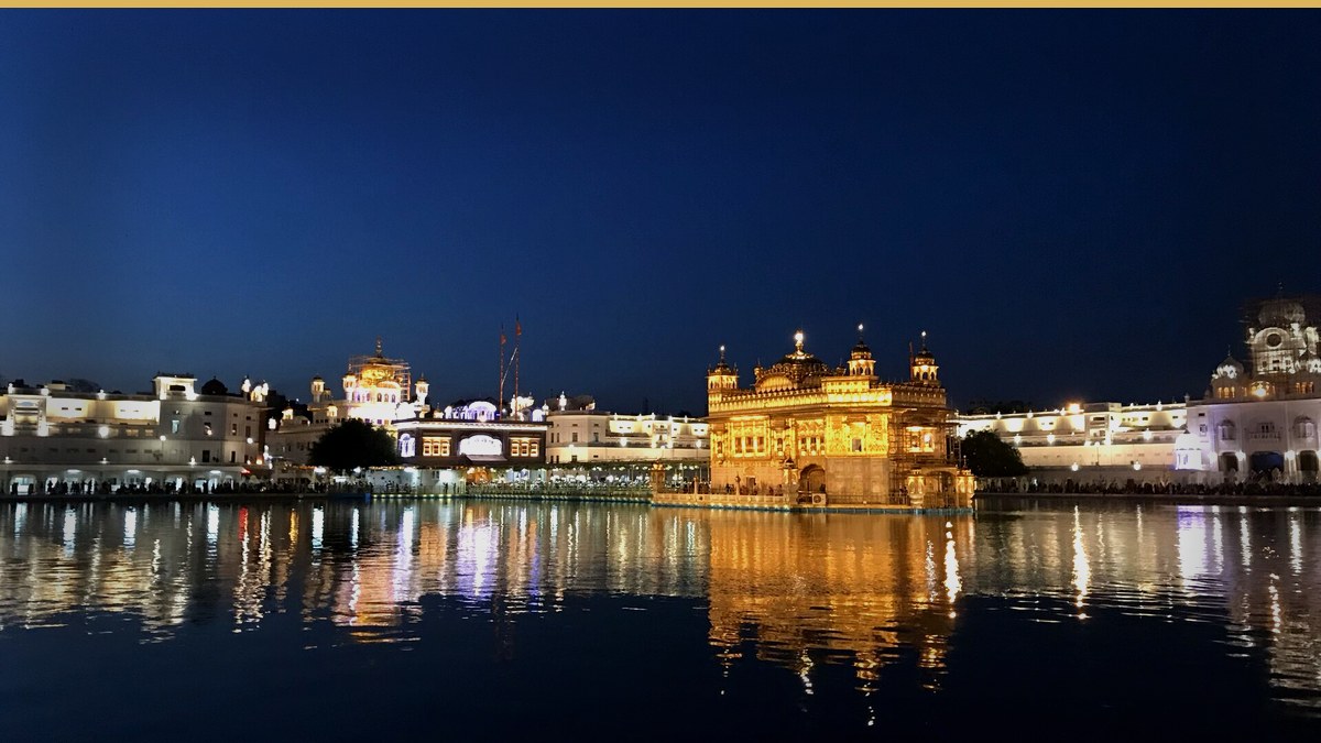 Photoreal editorial cover: Golden Temple Amritsar illuminated at night for Guru Nanak Jayanti 2026 Gurpurab date guide.