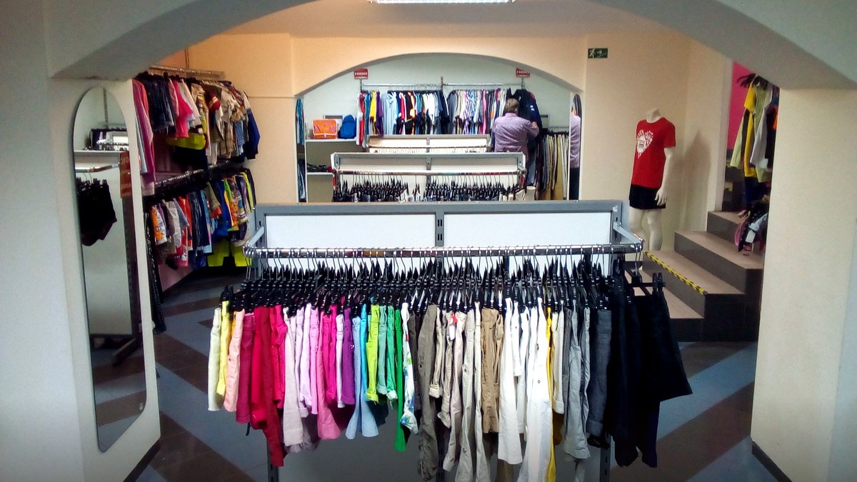 Photoreal thrift clothing racks for India thrifting boom culture guide — no named faces.