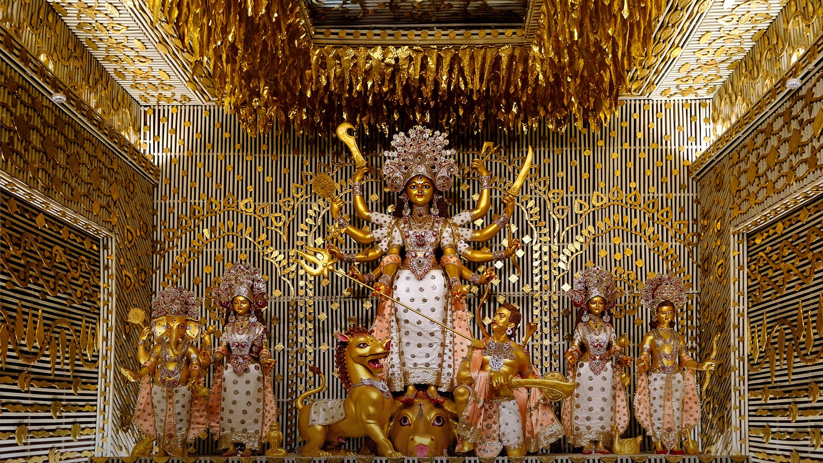 Real photograph of a gilded Durga Puja pandal in Kolkata (Chalta Bagan 2019, Wikimedia Commons) for the October 2026 festival calendar India guide.