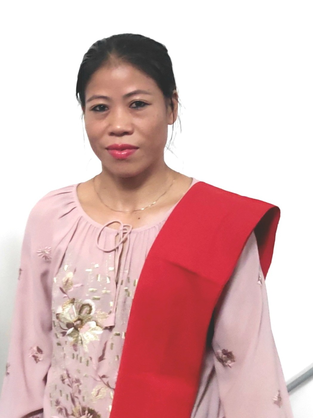 Mary Kom in a pink embroidered top and red stole, cropped from a 2025 photograph titled 'Karate Coach Dr. Pradeep Kumar Yadav with 6 World Boxing Champion Ms. Mary Kom'.