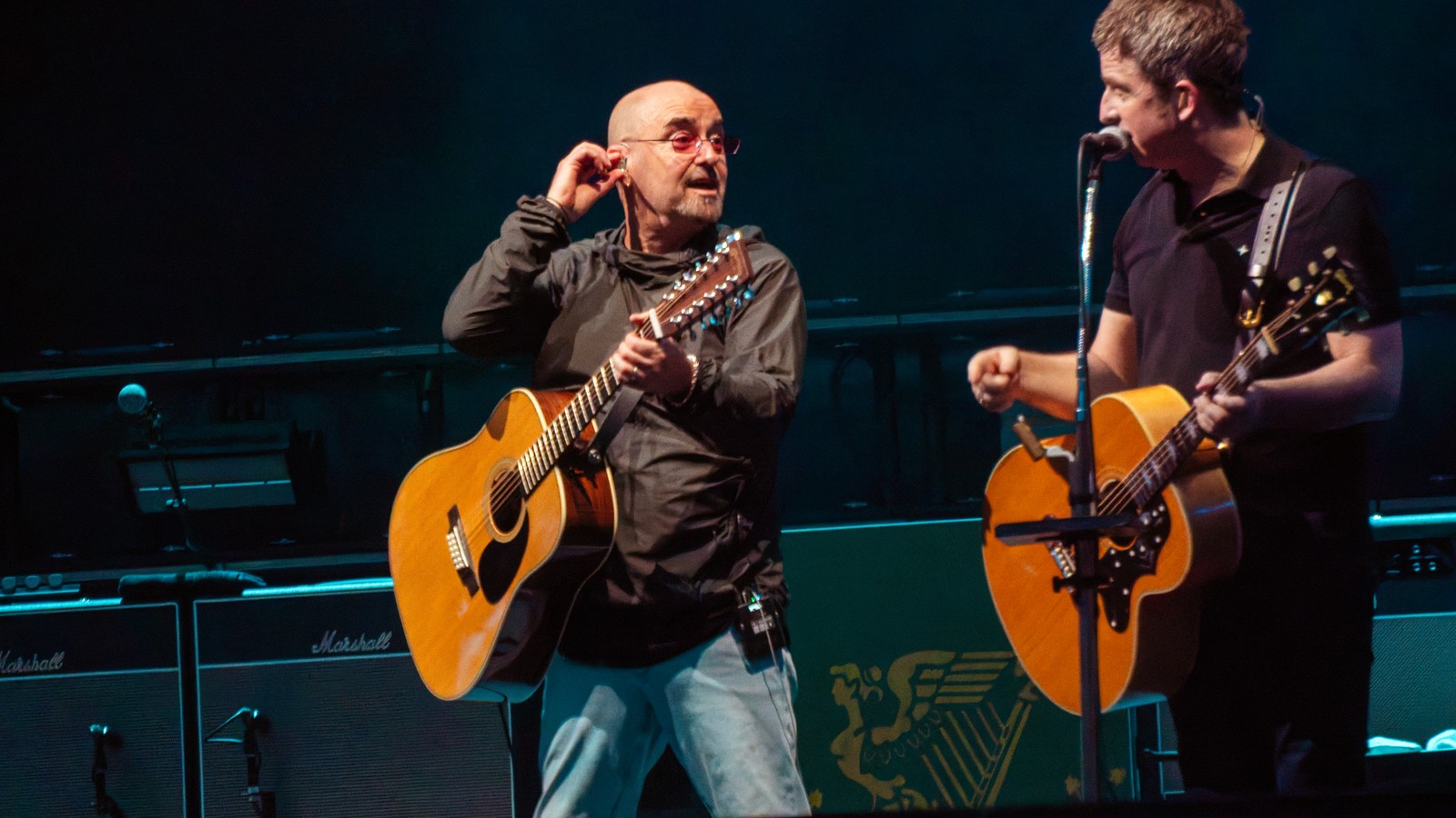 Oasis guitarists Bonehead and Noel Gallagher on stage at Wembley Stadium, London, Aug. 3, 2025
