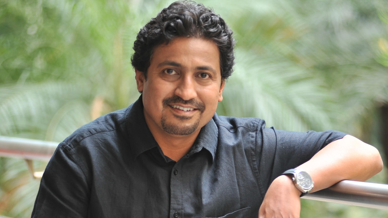 Film director Vinod Kapri seated outdoors