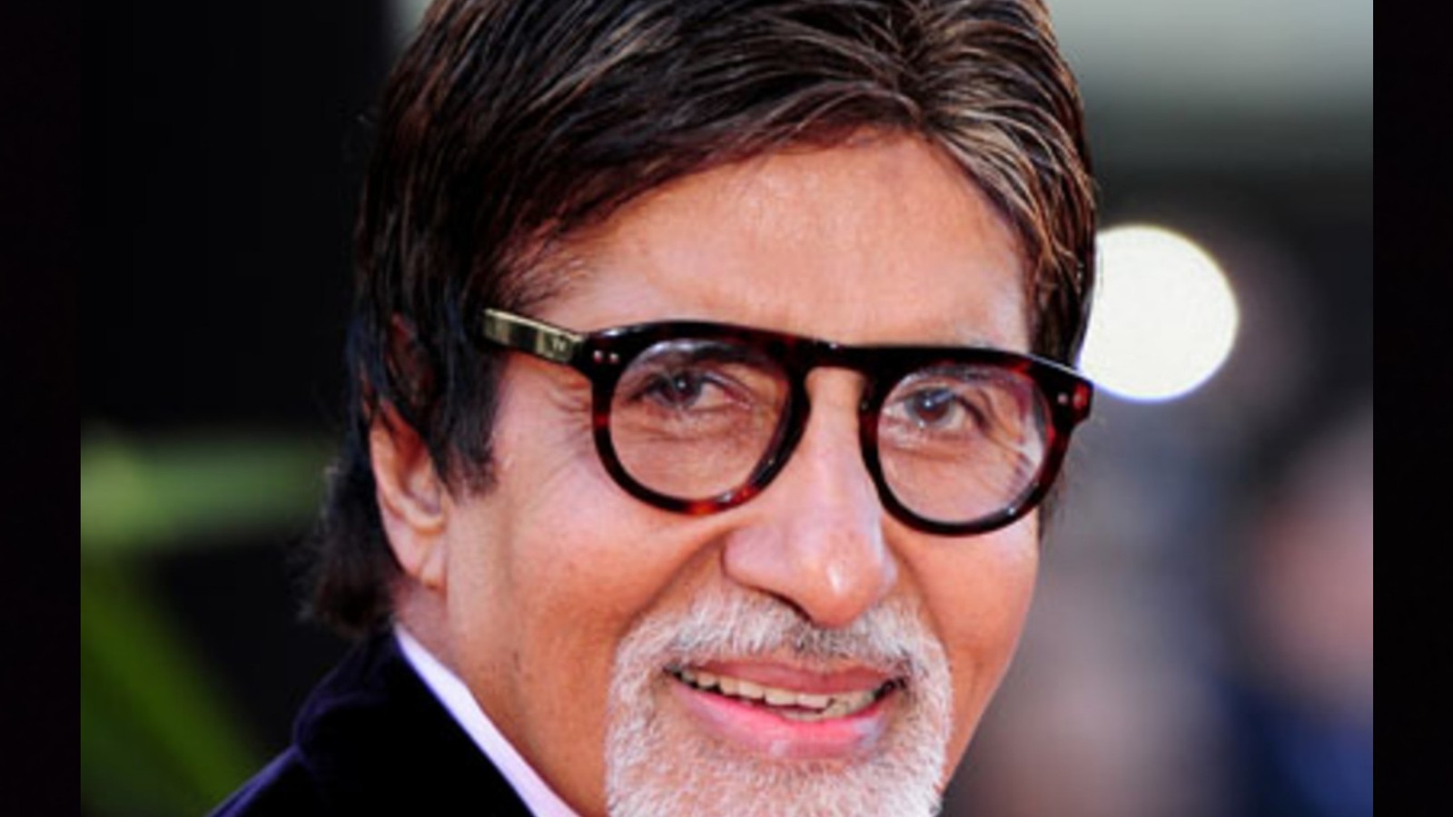 Close portrait of actor Amitabh Bachchan in round glasses