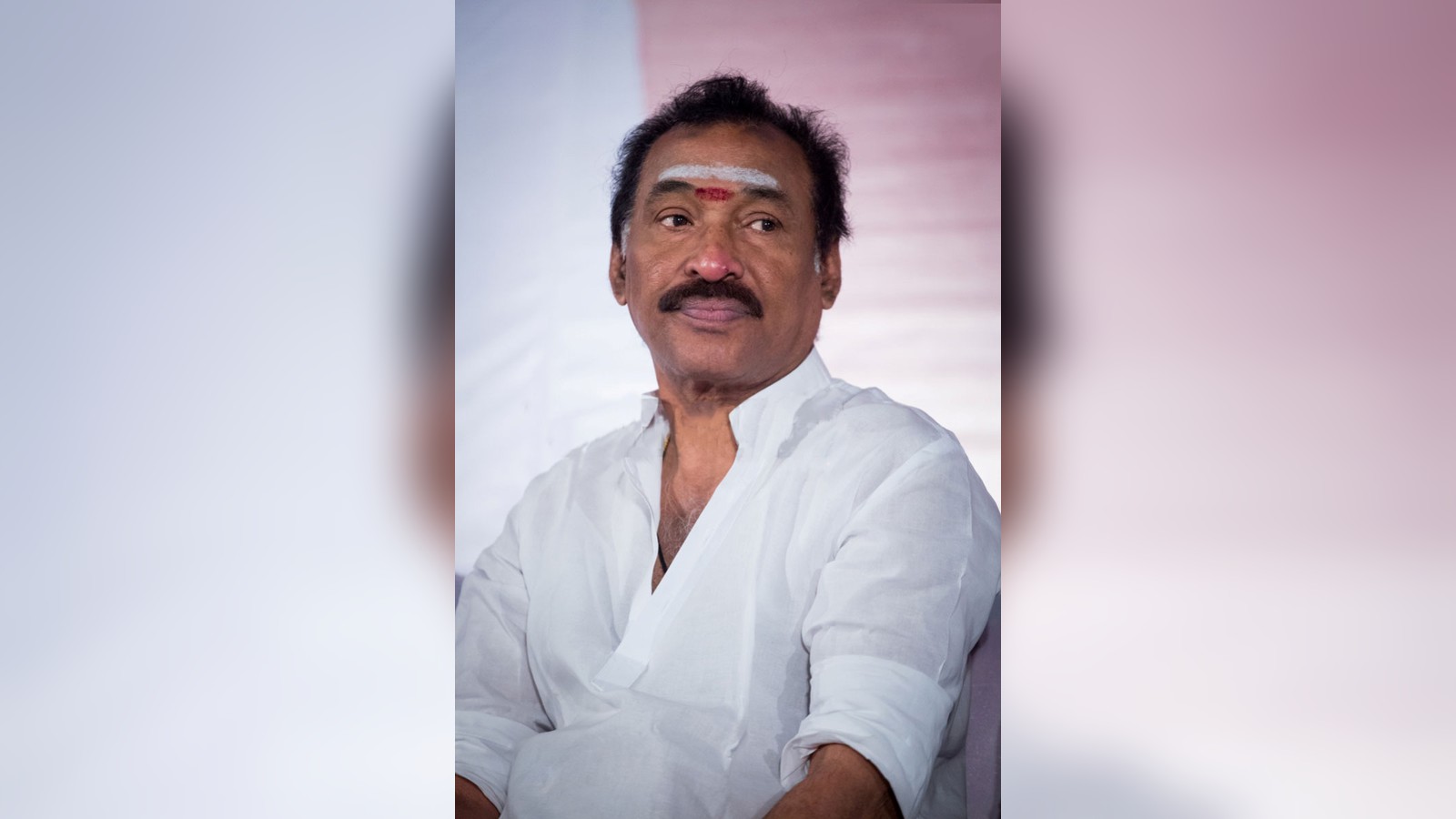 Music director Deva in a white shirt at a press meet