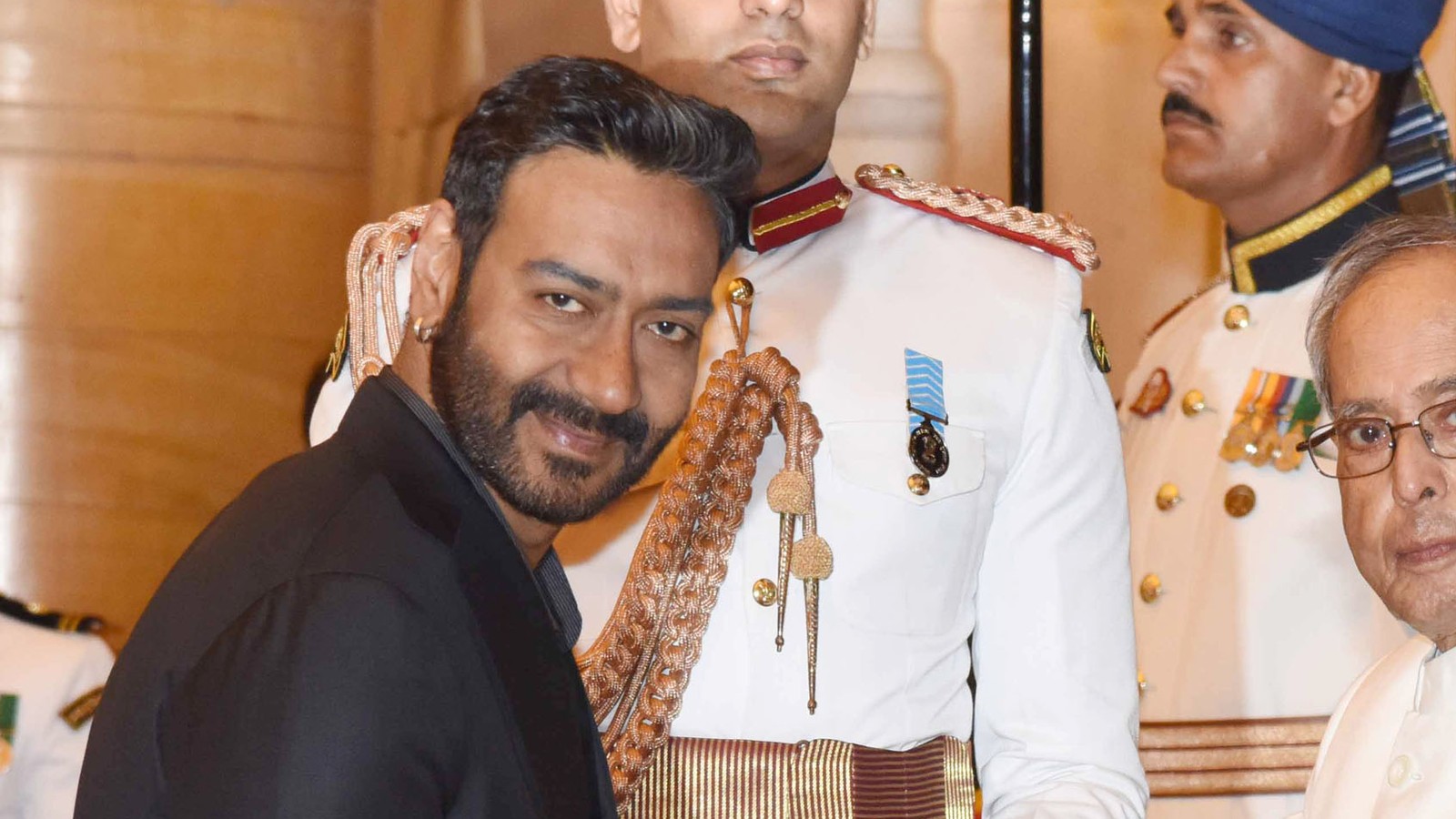Ajay Devgn receiving the Padma Shri from the President of India