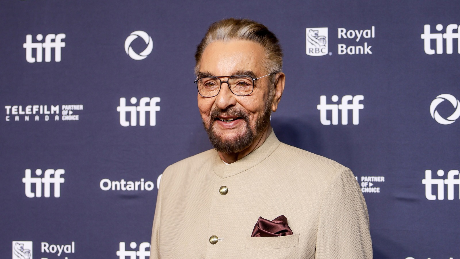 Actor Kabir Bedi in a cream jacket and glasses at the Toronto International Film Festival
