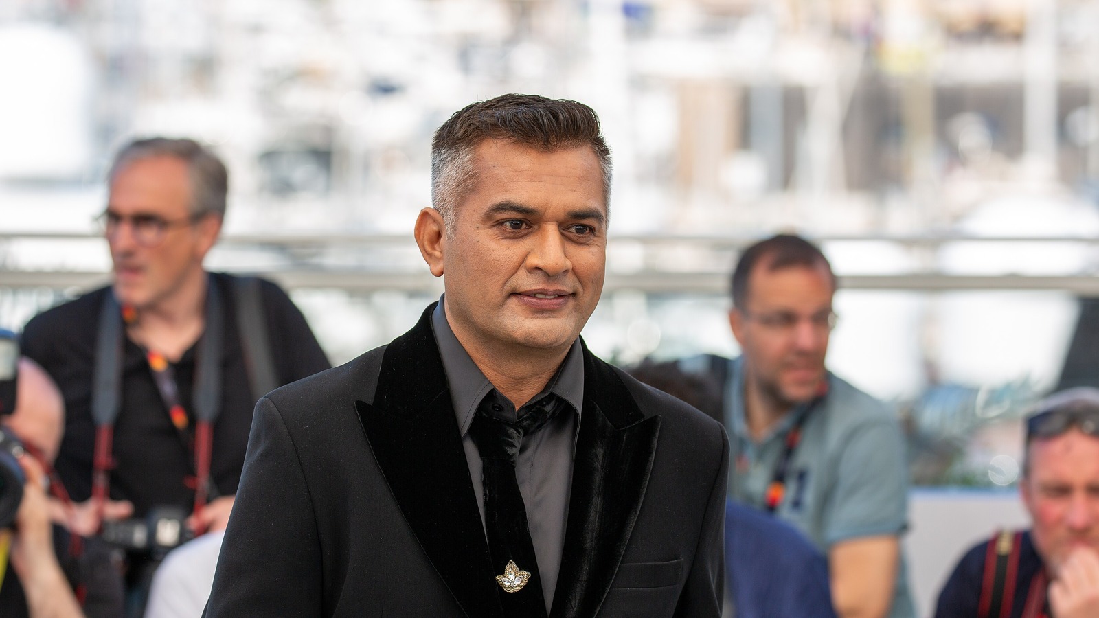 Director Neeraj Ghaywan in a black velvet jacket at the 2025 Cannes Homebound photocall