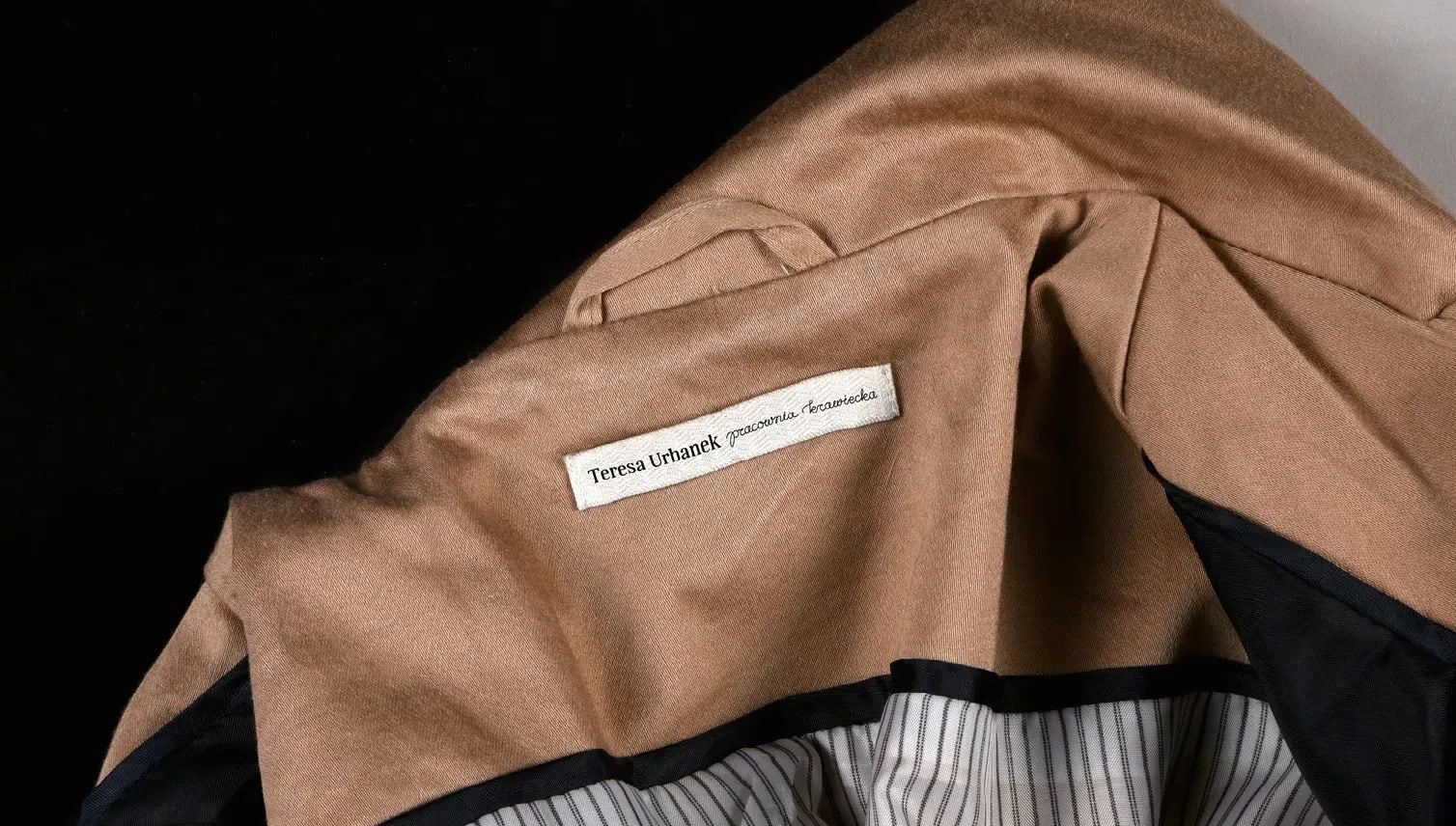 Metka z logo Pracowni Krawieckiej Teresy Urbanek. Label with Teresa Urbanek logo.