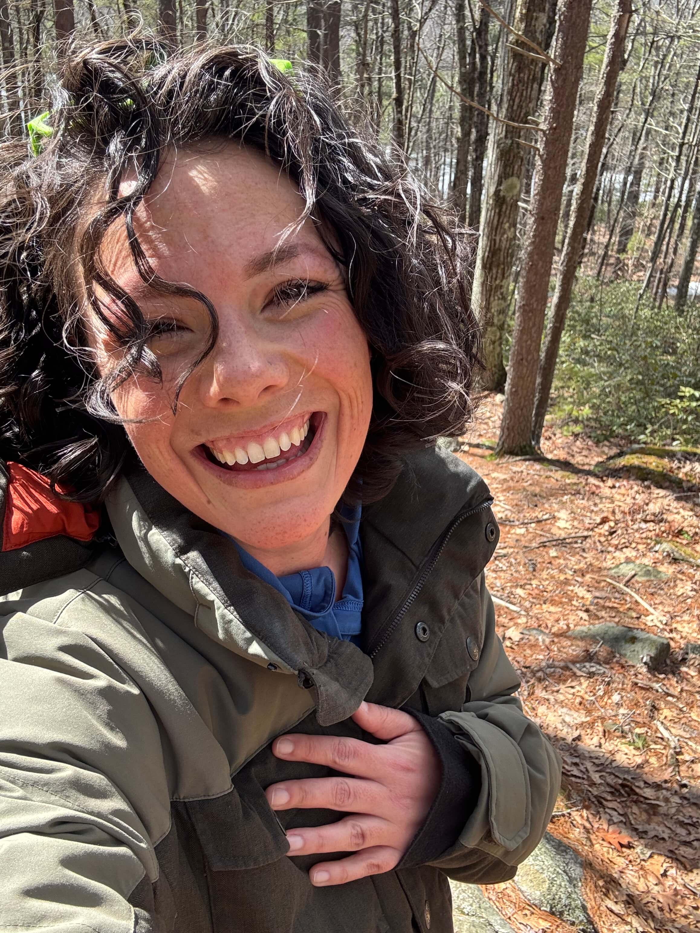 Grace Mahoney in the woods, laughing