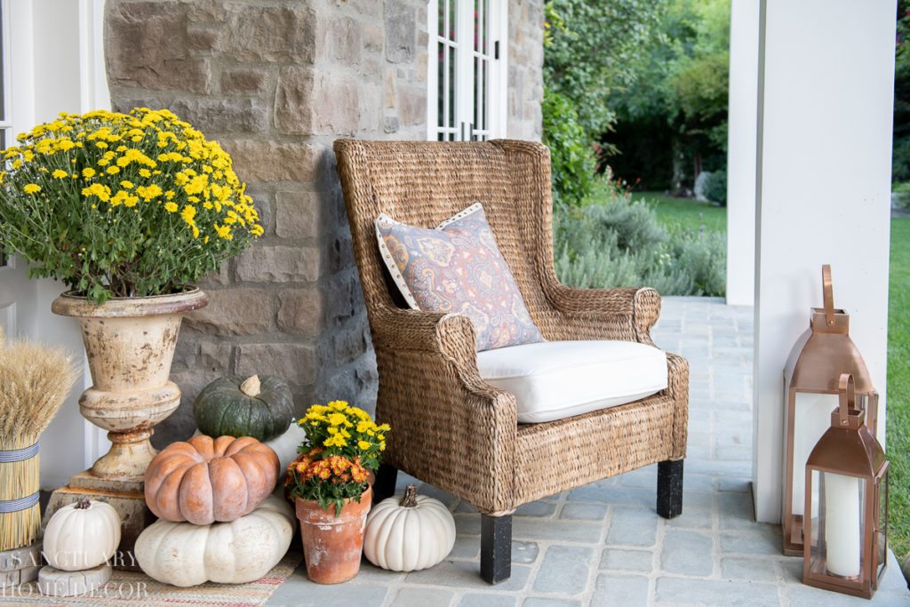 wicker rocking chairs potted mums porch