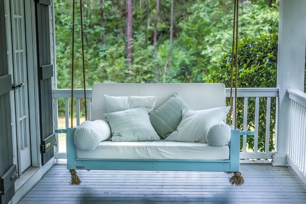 porch swing piled pillows autumn colors