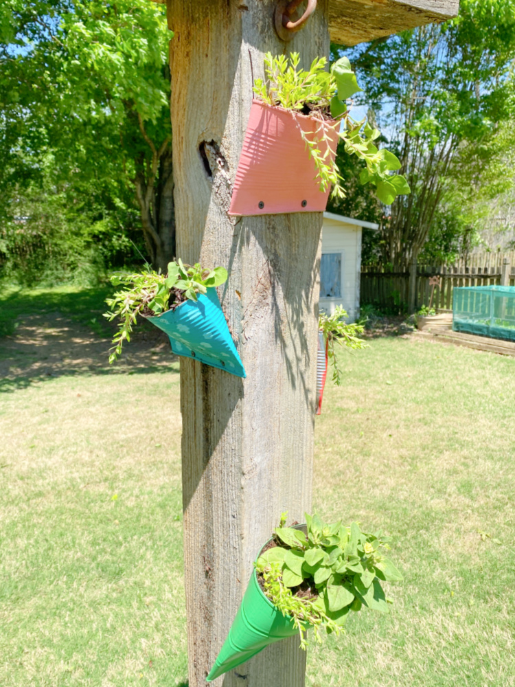 tin can planter shaped like birdhouse