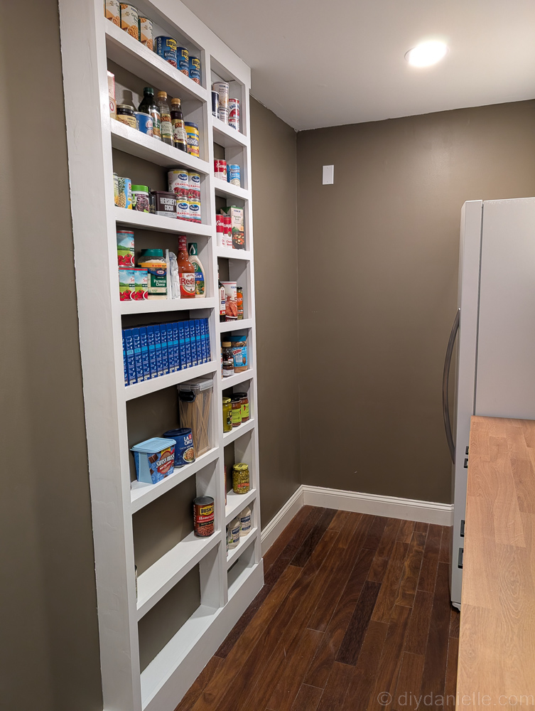 tin cans mounted on wooden wall as pockets