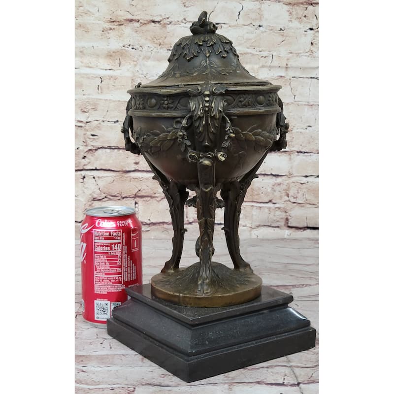 tin cans on pedestal stand with flowers
