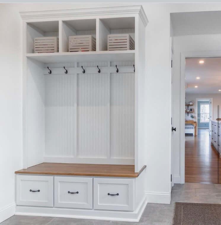 organized wooden entryway bench with hooks