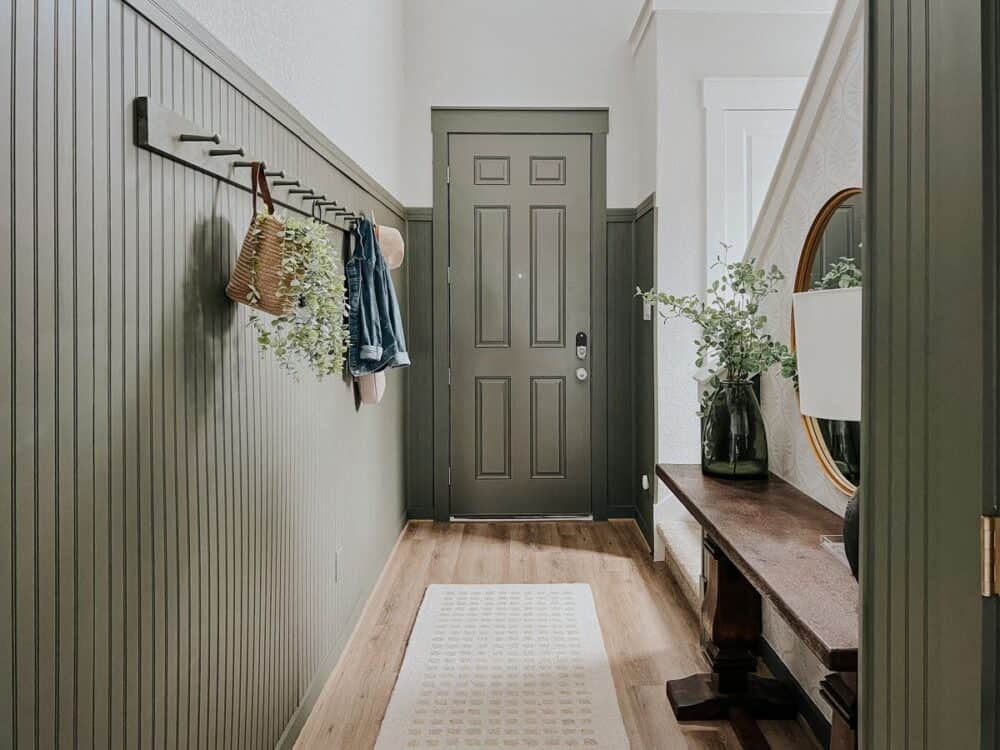 long wooden peg rail with coats entryway