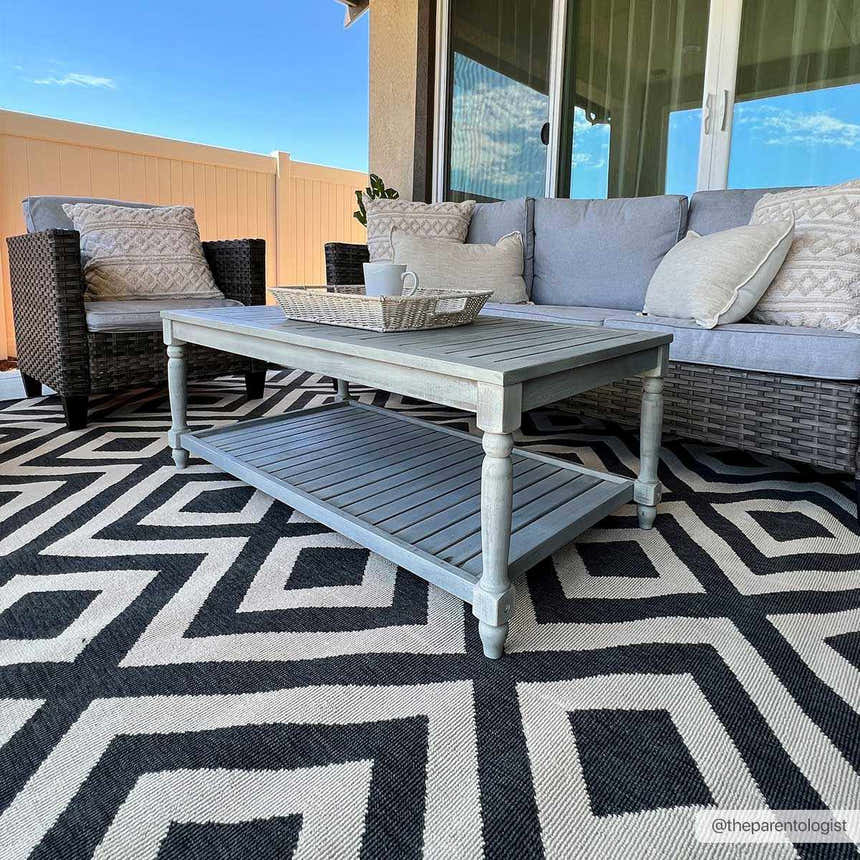 patterned outdoor rug under patio dining set