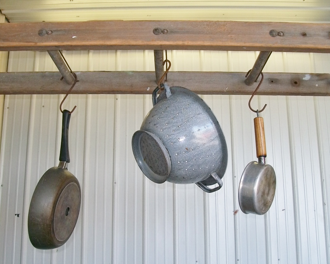 wooden ladder hanging pots and pans
