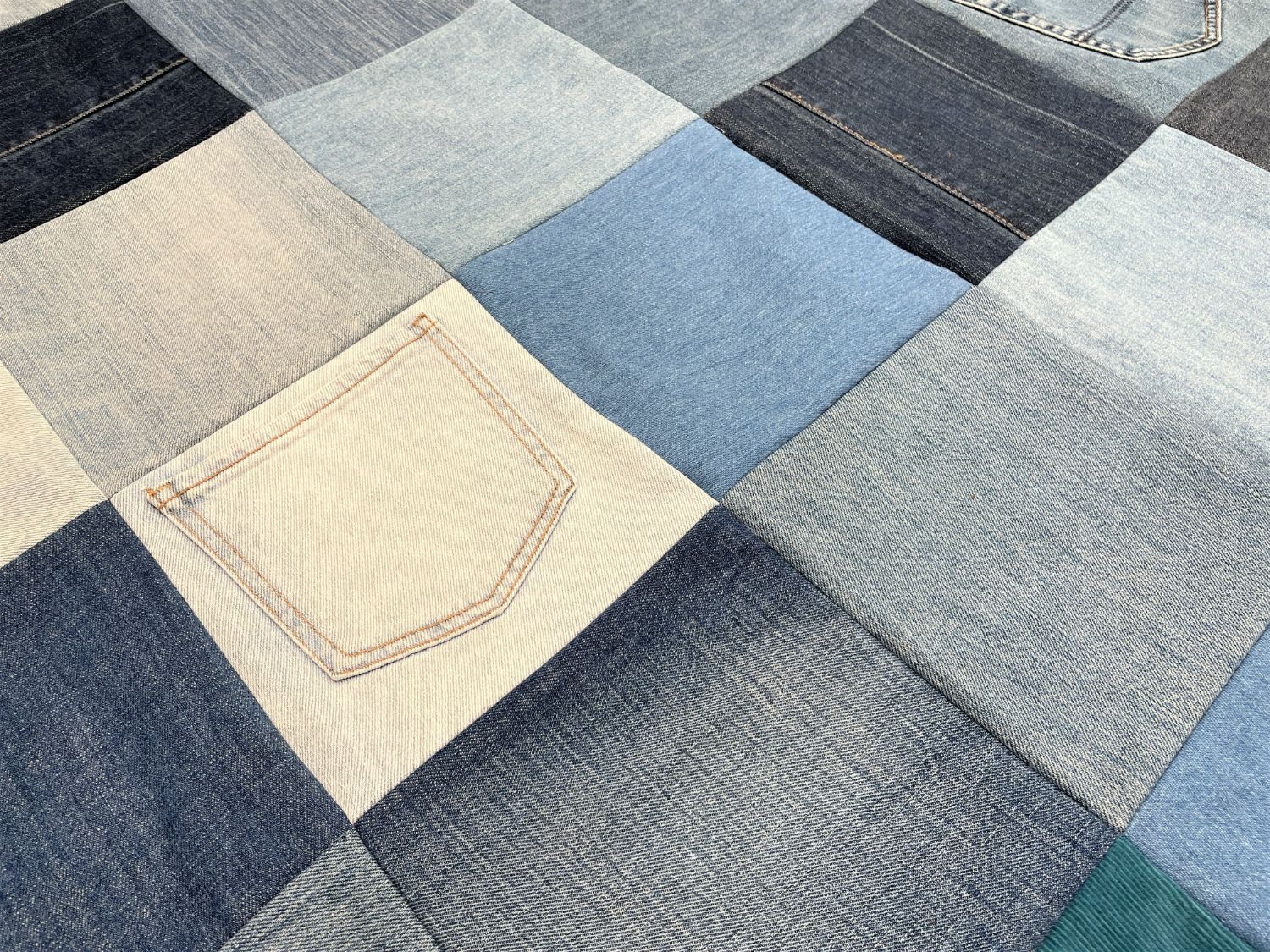 denim patchwork quilt on bed