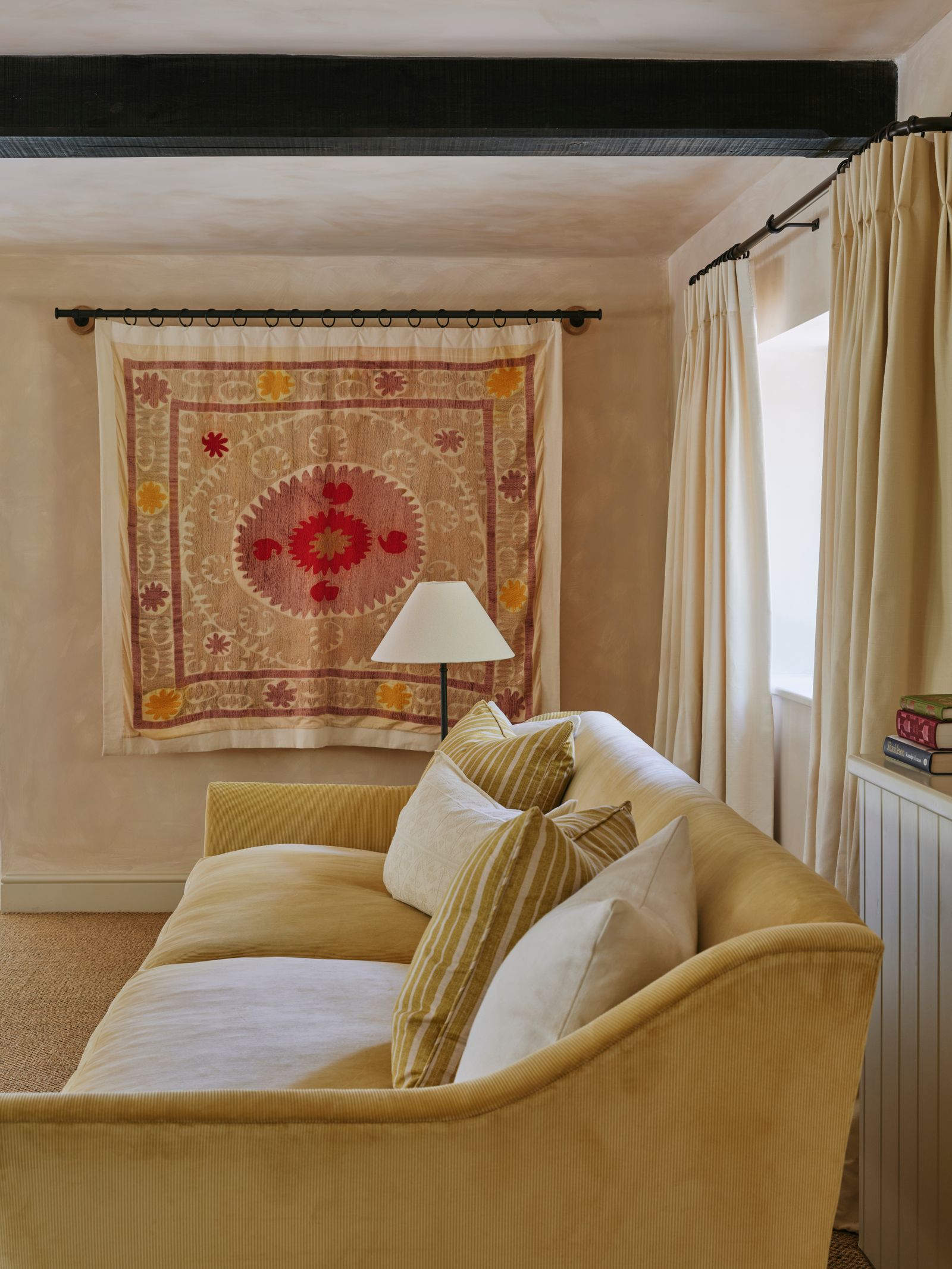 woven tapestry hanging in living room corner