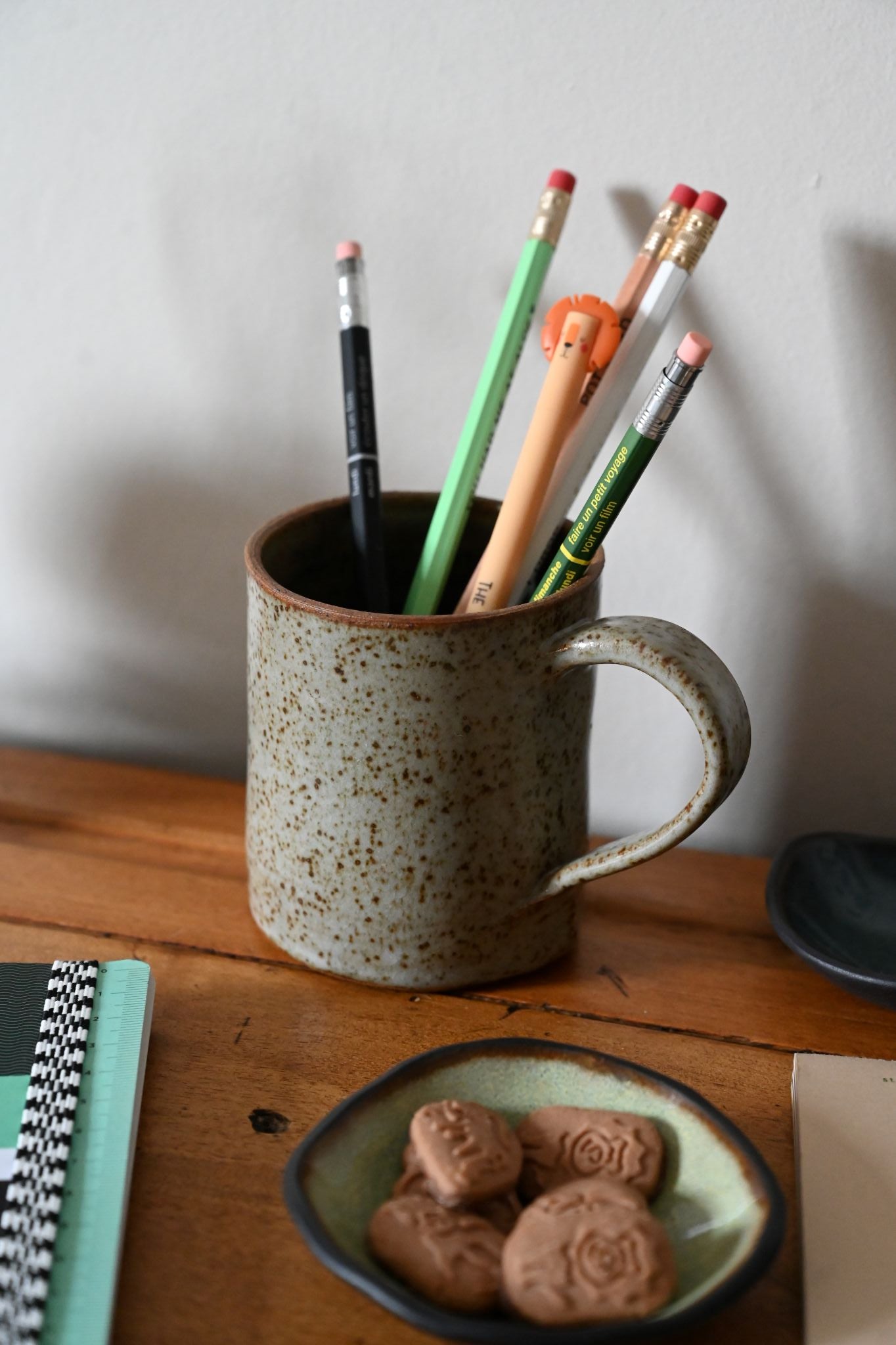 ceramic mug used as pencil holder on desk