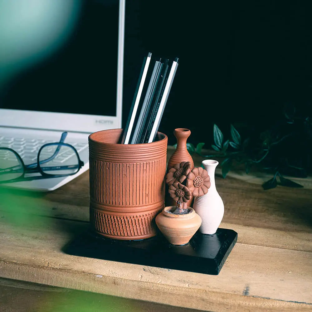terracotta pot pencil holder on wooden desk