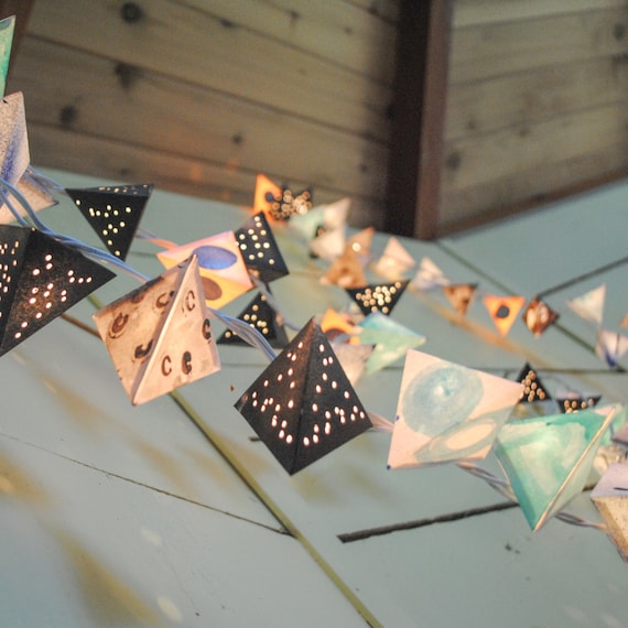 origami paper lanterns hanging outdoors