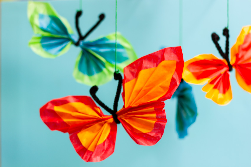 paper butterfly mobile near window