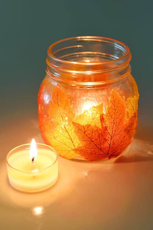glass jar fall lantern with candle and leaves