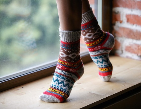 cozy sweater slippers on hardwood floor