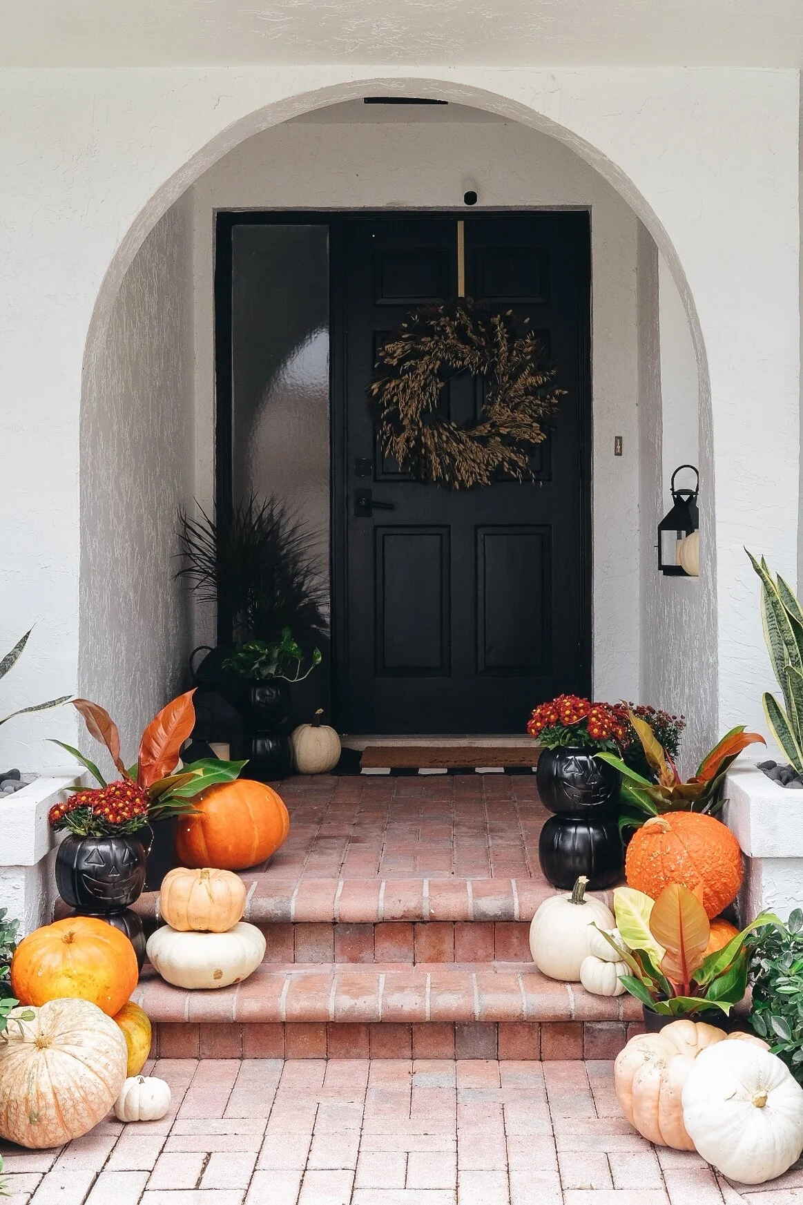 fall decorated front porch with pumpkins