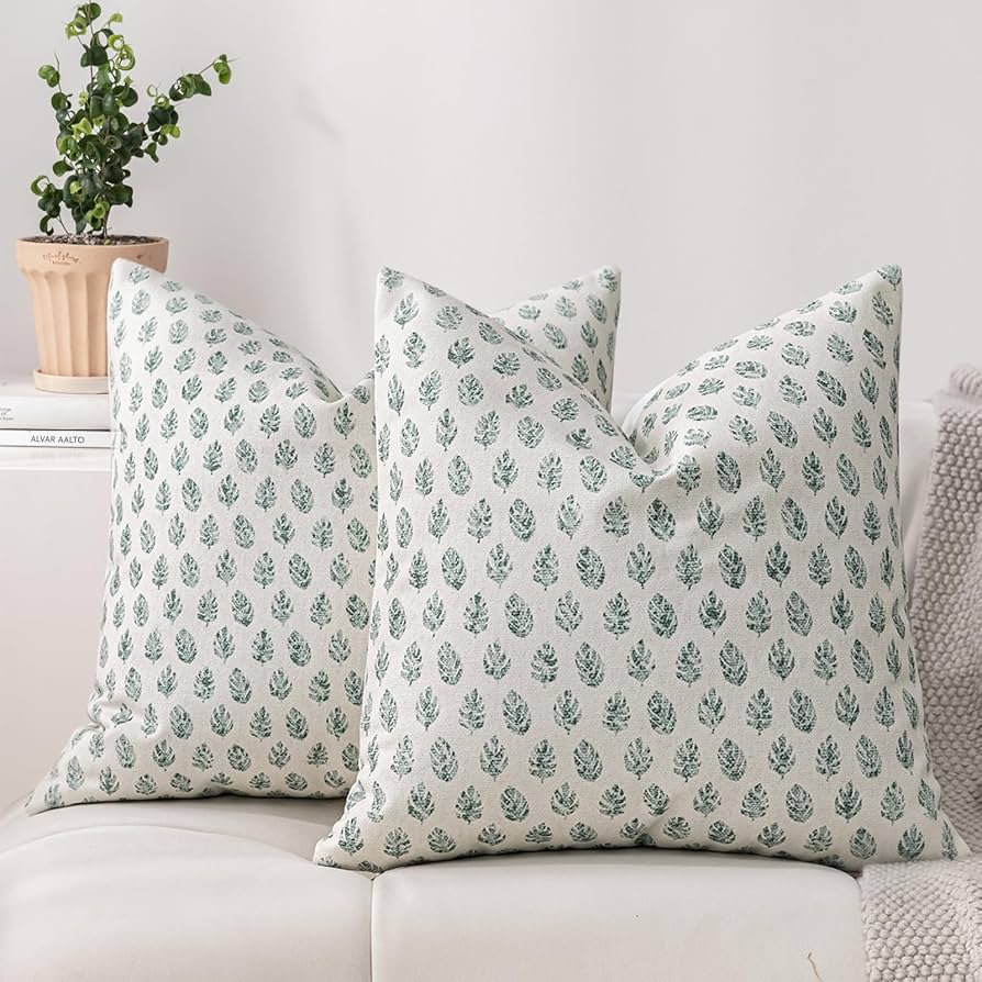 leaf printed throw pillows on sofa
