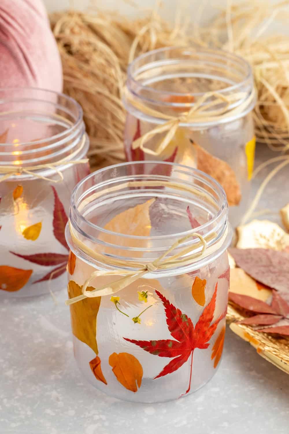 mason jar with pressed leaves and candle fall leaf craft home decor