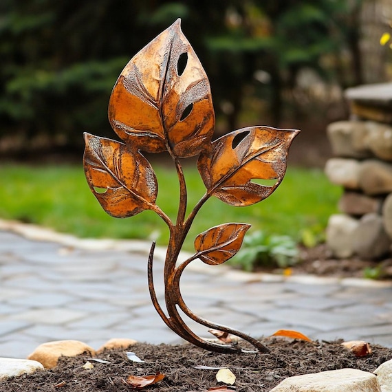 leaf sculpture in garden bed