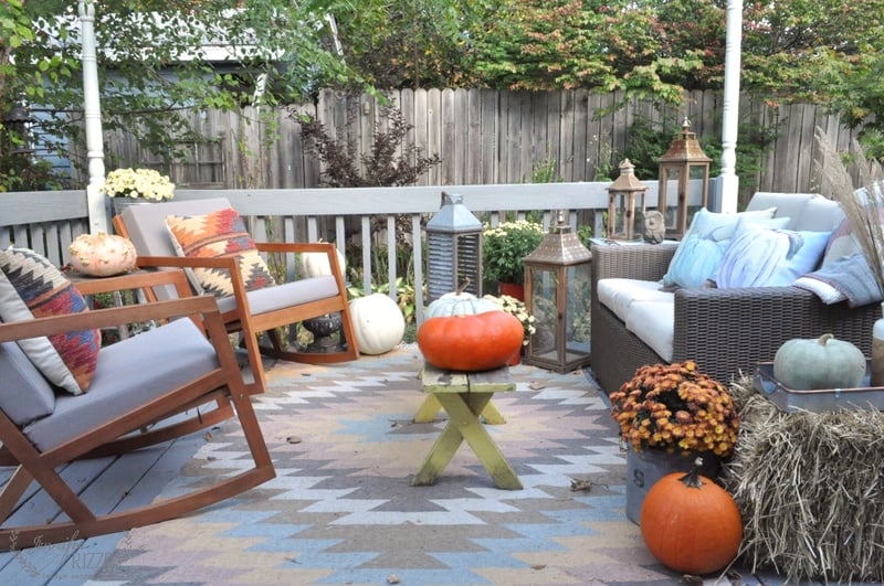 fall garden with pumpkins lanterns and mums