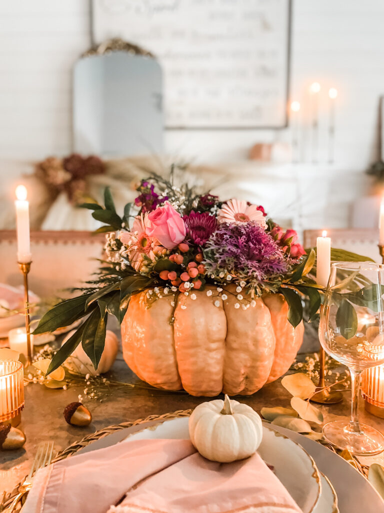 fall pumpkin centerpiece with candles on dining table